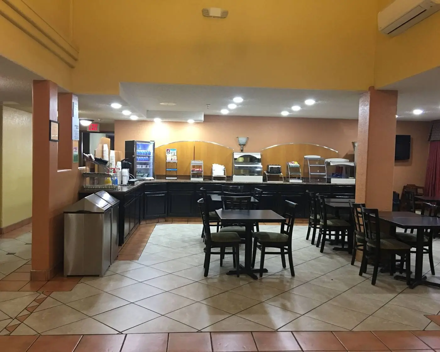 Breakfast area with tables and a buffet counter